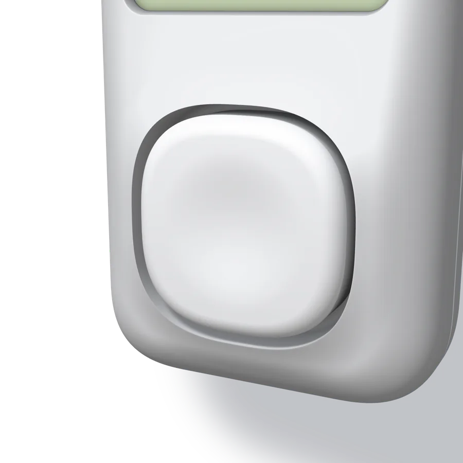 A close-up of the key: a pillow-shaped white cap standing a little proud of a sharp-edged well in the swelled front face